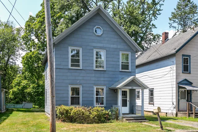 a front view of a house with garden