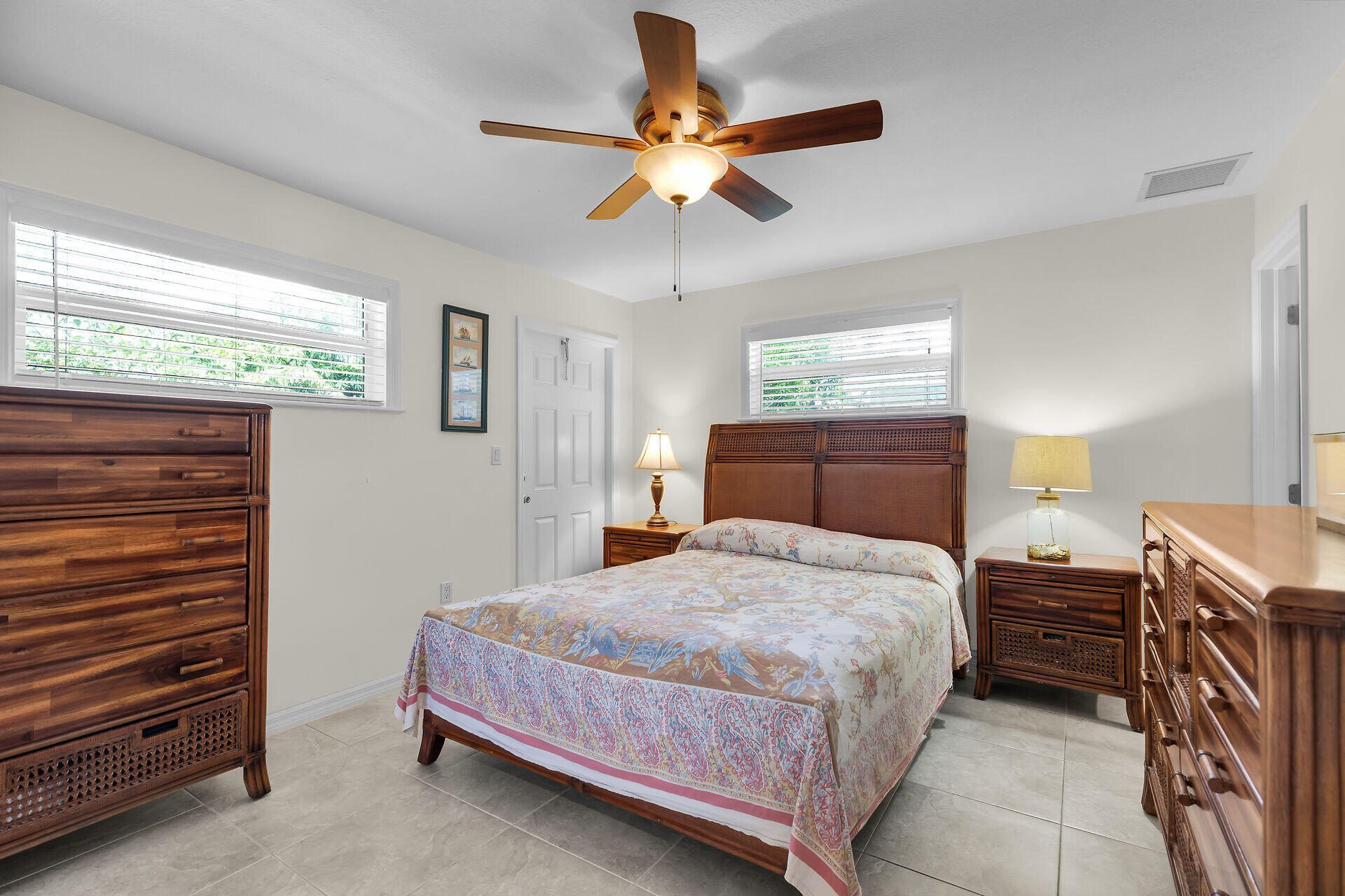 894 La Paloma Road Key Largo, FL 33037 - Photo 16 of 37 a bedroom with a bed and a chandelier