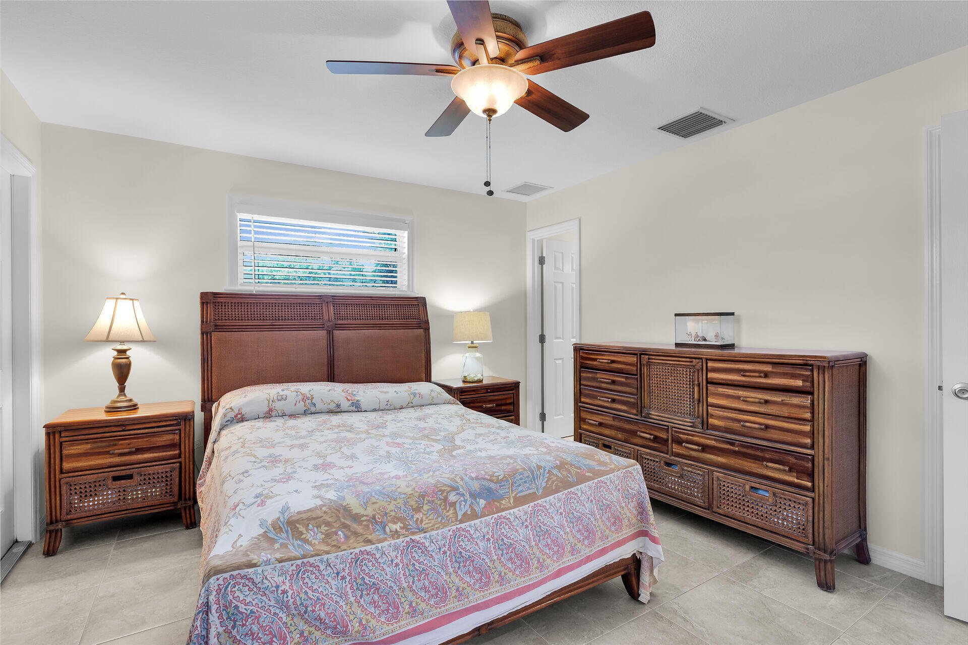 894 La Paloma Road Key Largo, FL 33037 - Photo 17 of 37 a bedroom with a bed and a chandelier