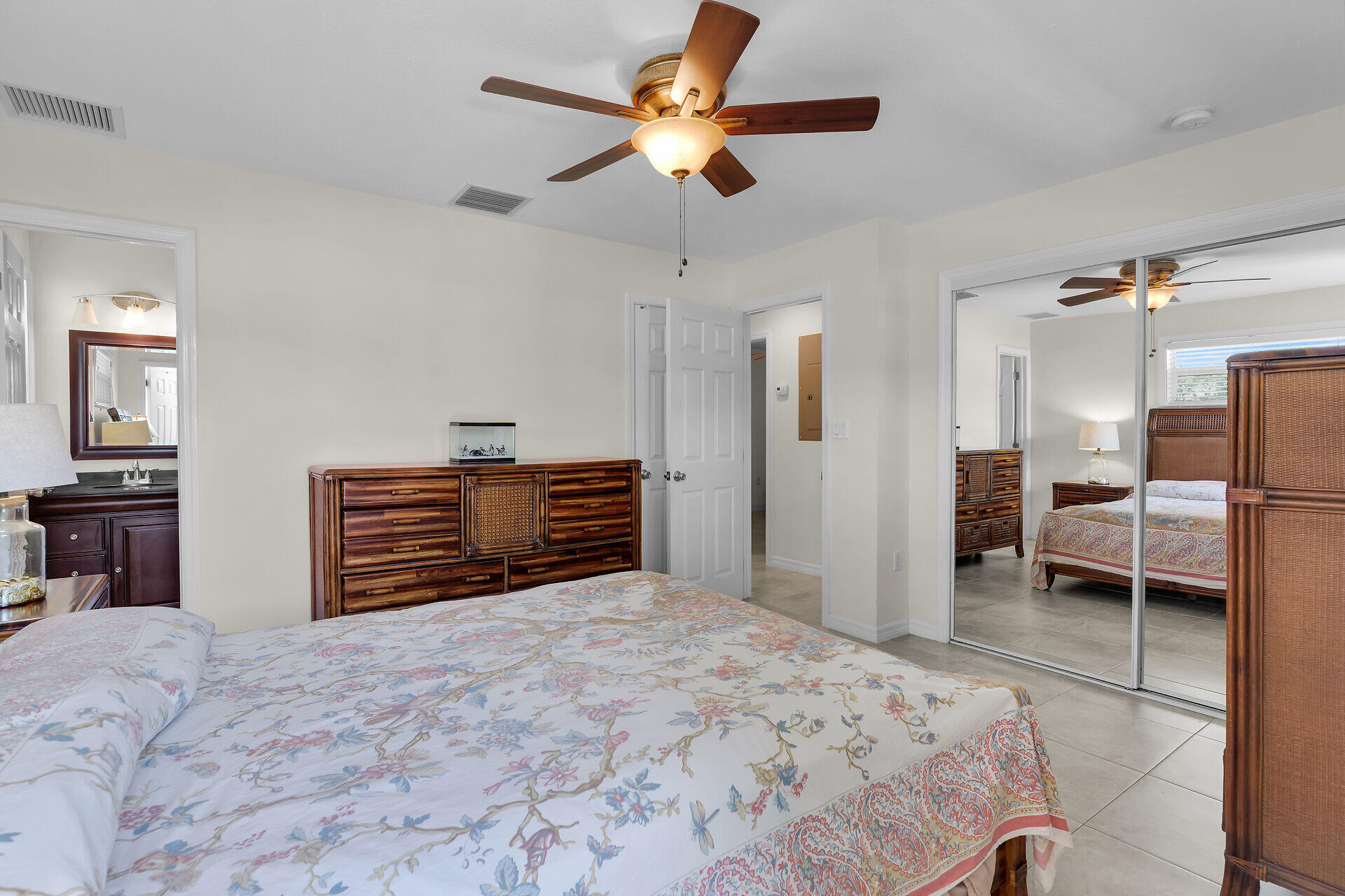 894 La Paloma Road Key Largo, FL 33037 - Photo 18 of 37 a bedroom with a bed and a chandelier