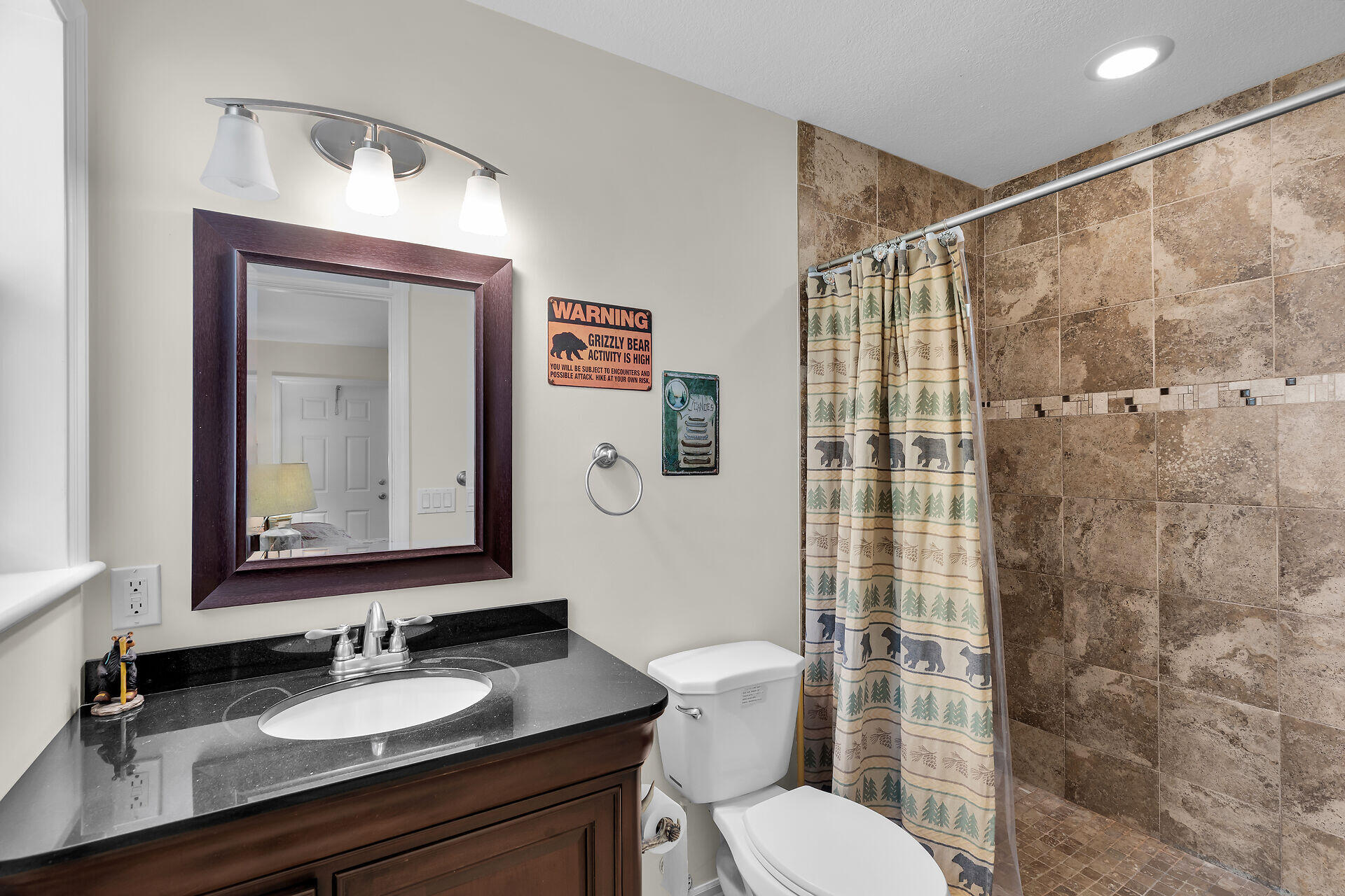 894 La Paloma Road Key Largo, FL 33037 - Photo 19 of 37 a bathroom with a granite countertop sink toilet a mirror and shower