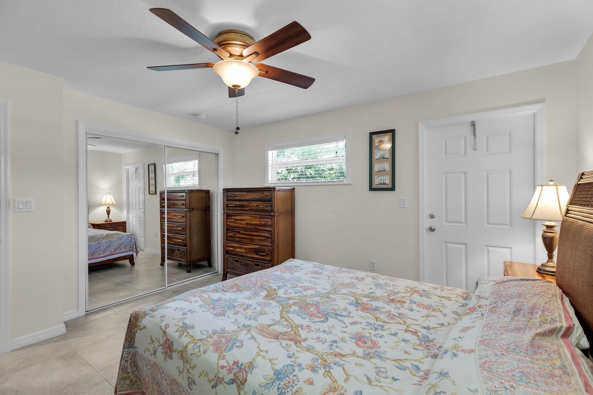 894 La Paloma Road Key Largo, FL 33037 - Photo 20 of 37 a bedroom with a bed and a chandelier