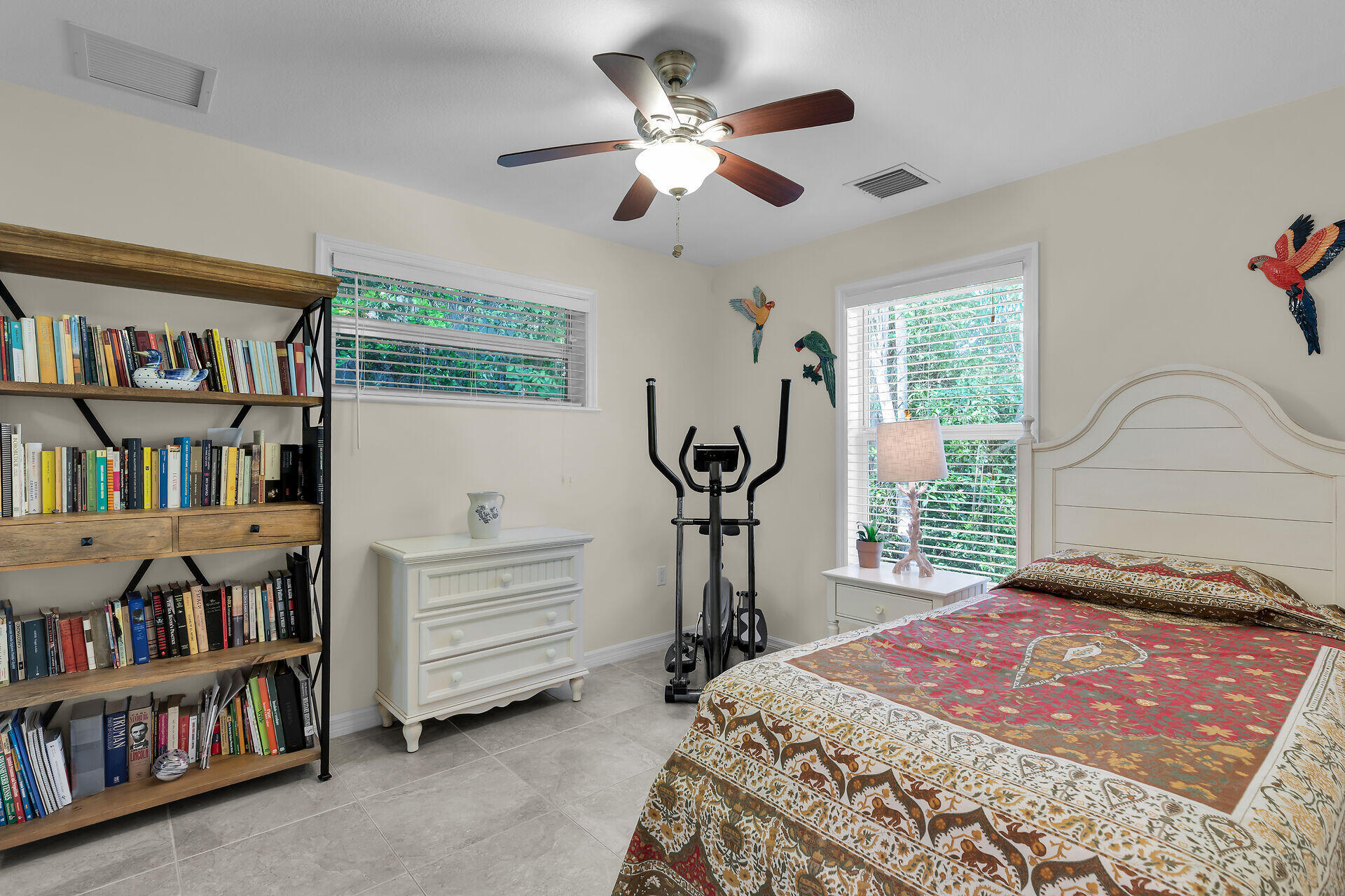 894 La Paloma Road Key Largo, FL 33037 - Photo 21 of 37 a bedroom with a bed a book shelf and a window