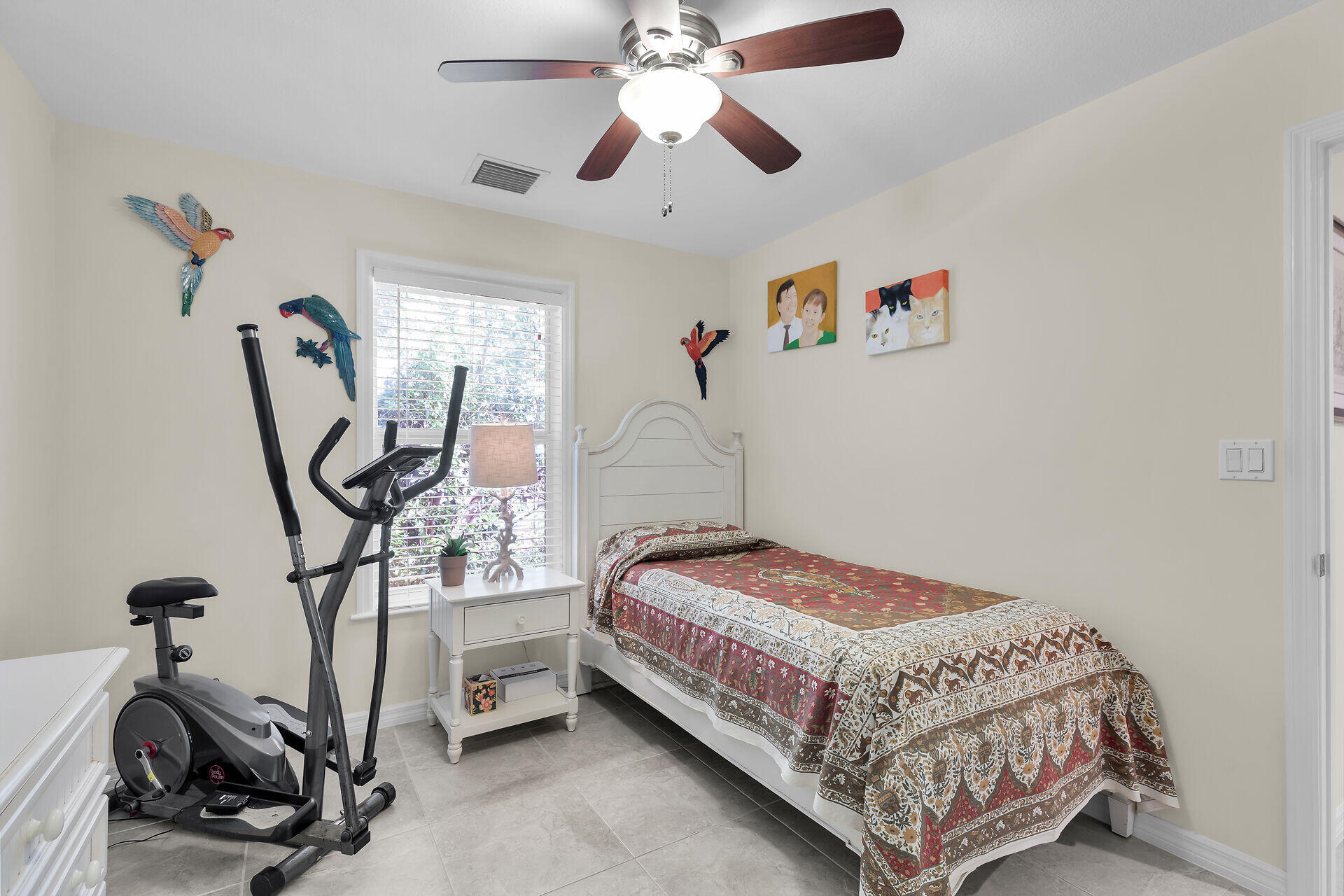 894 La Paloma Road Key Largo, FL 33037 - Photo 23 of 37 a bedroom with bed a ceiling fan and a window