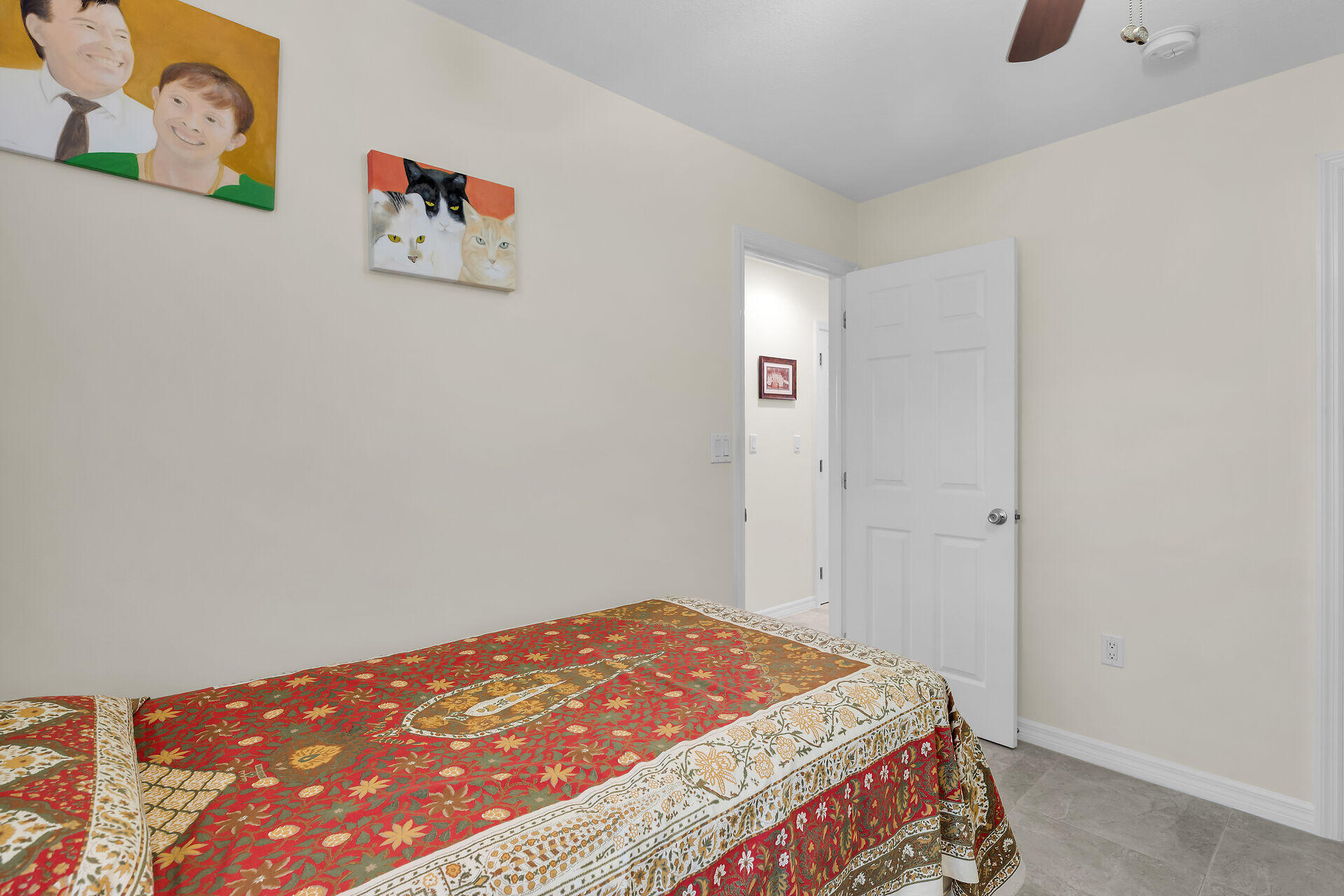 894 La Paloma Road Key Largo, FL 33037 - Photo 24 of 37 a bedroom with a bed and painting on the wall