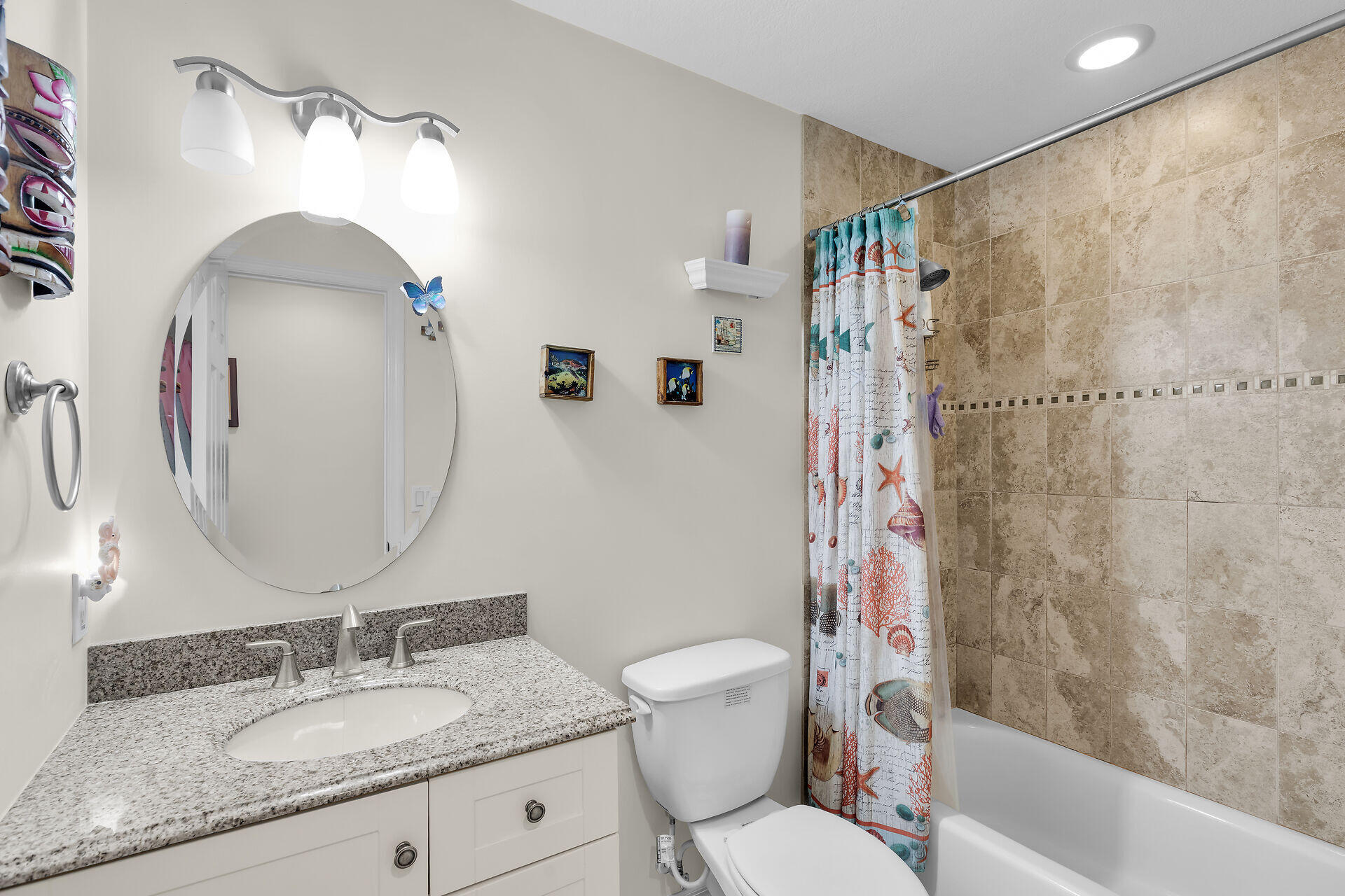 894 La Paloma Road Key Largo, FL 33037 - Photo 25 of 37 a bathroom with a granite countertop sink toilet and shower