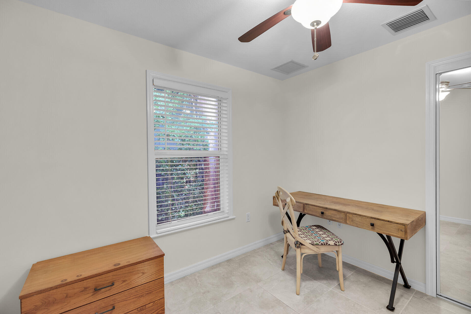 894 La Paloma Road Key Largo, FL 33037 - Photo 27 of 37 a room with a chair and a window