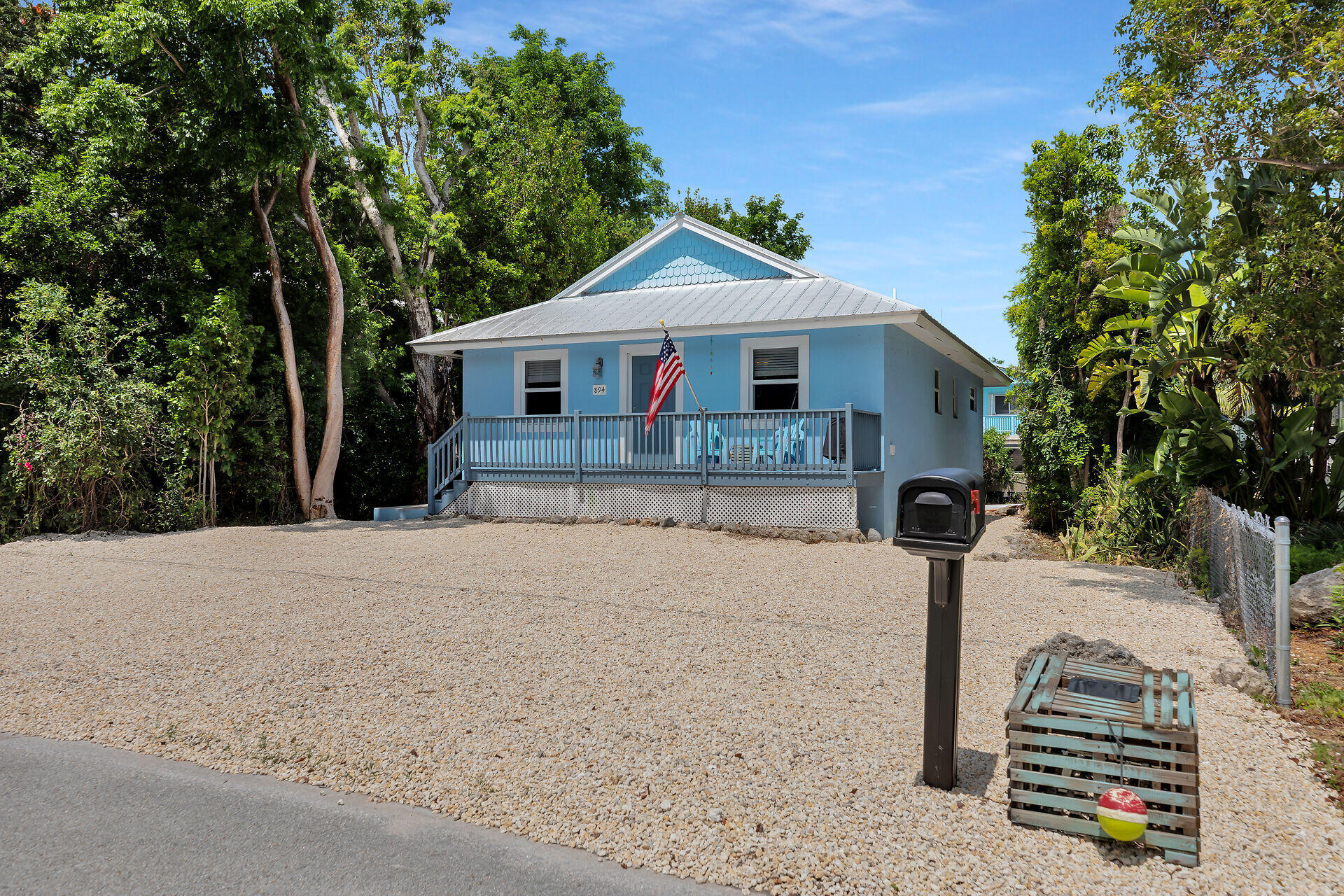 894 La Paloma Road Key Largo, FL 33037 - Photo 36 of 37 a front view of a house with a yard and garage