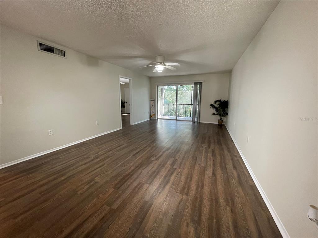 112 Palmetto Court, Unit 112 Oldsmar, FL 34677 - Photo 12 of 46 wooden floor in an empty room with a window