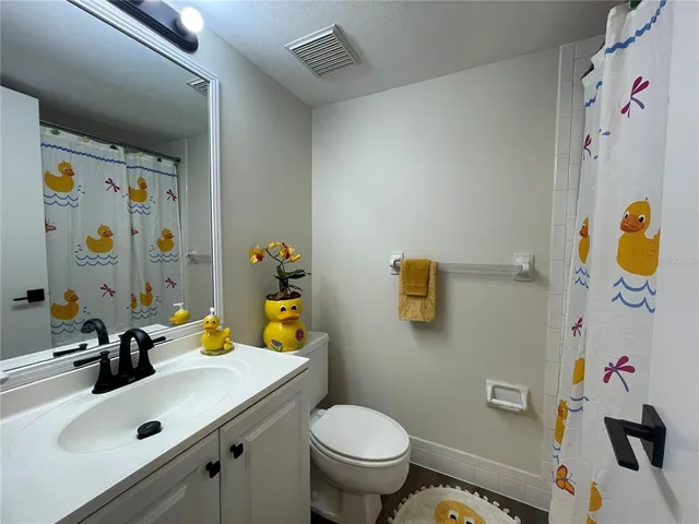a bathroom with a sink mirror vanity and toilet