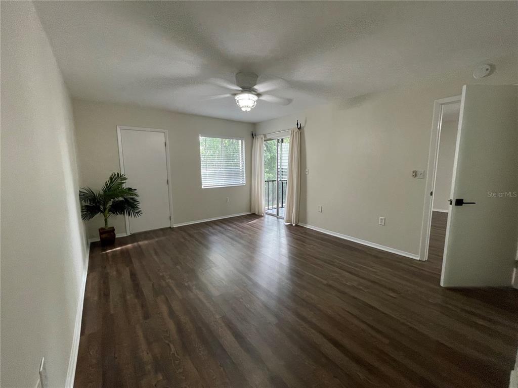 112 Palmetto Court, Unit 112 Oldsmar, FL 34677 - Photo 20 of 46 an empty room with wooden floor and windows