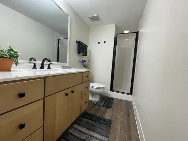 a bathroom with a double vanity sink and mirror