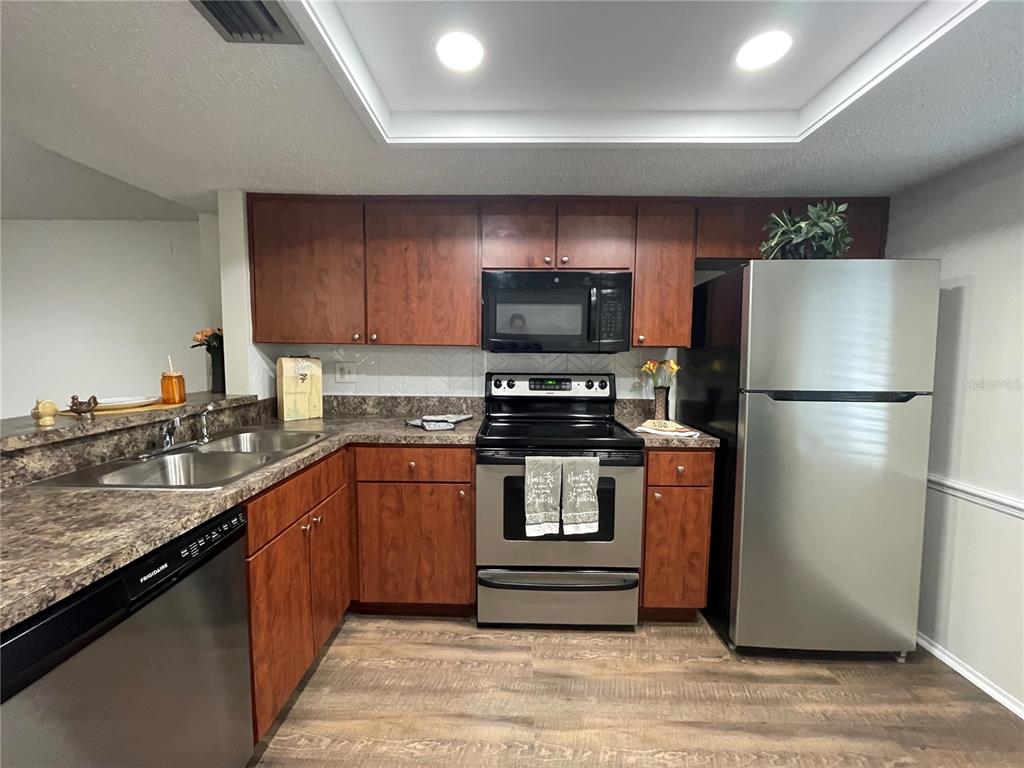 112 Palmetto Court, Unit 112 Oldsmar, FL 34677 - Photo 3 of 46 a kitchen with a refrigerator and a sink