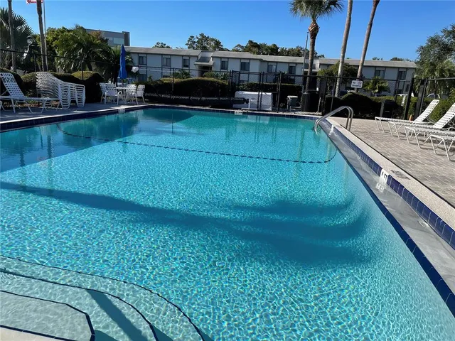 a view of a swimming pool with outdoor seating