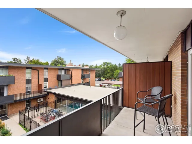 a balcony with furniture and a potted plant