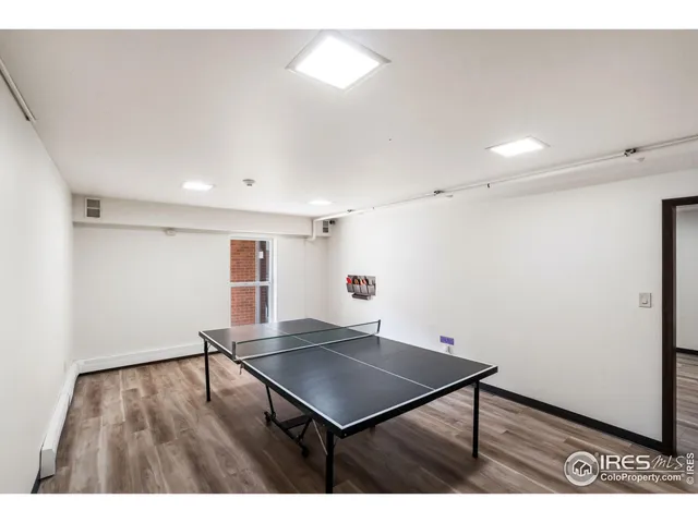 a room with pool table and windows