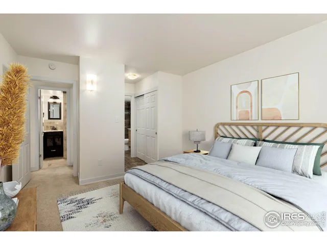 a bedroom with a bed painting on wall and a desk