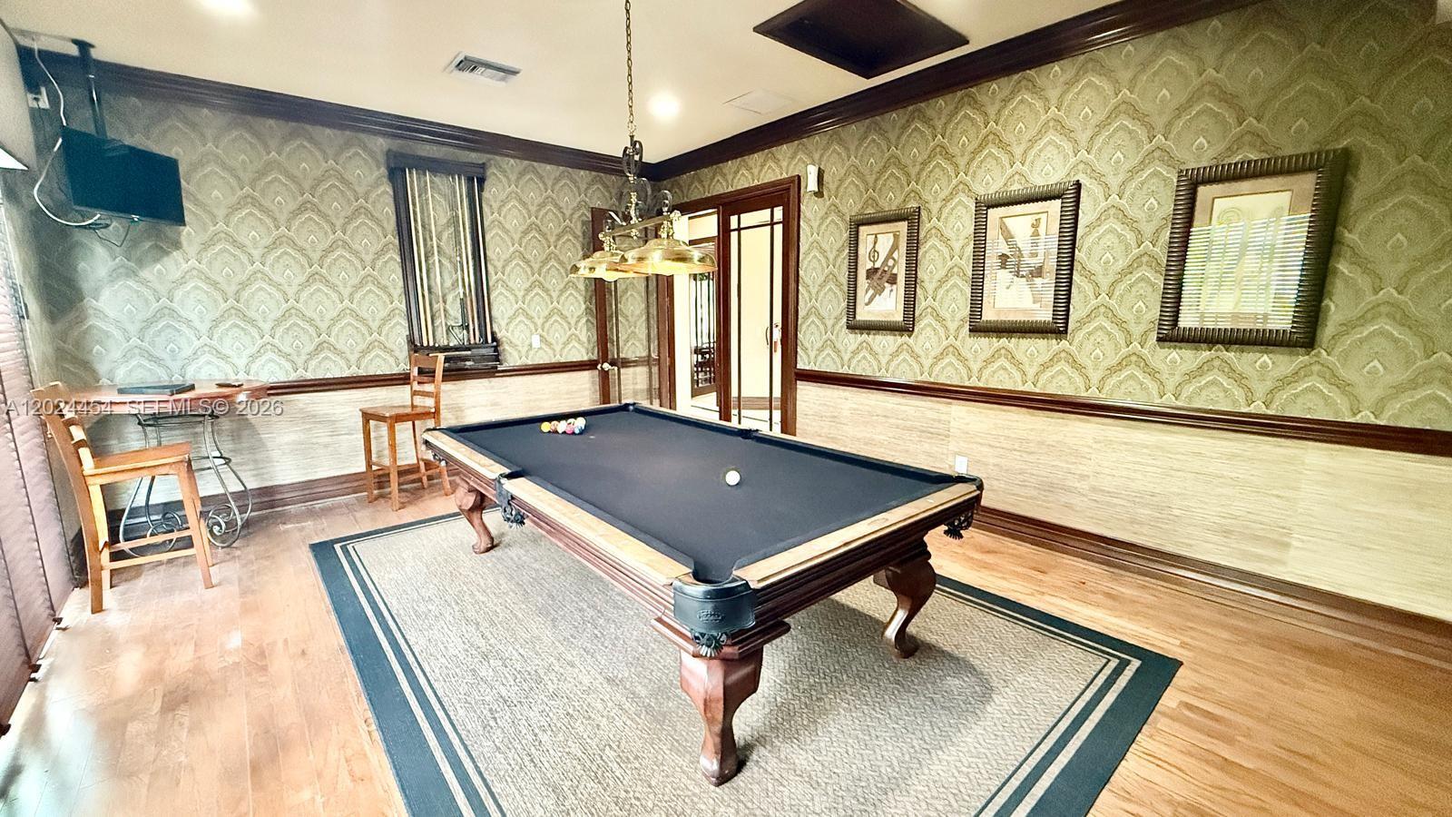 2727 Anzio Court, Unit 106 Palm Beach Gardens, FL 33410 - Photo 41 of 43 a room with wooden floor table and chairs