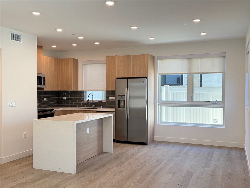 17814 Bullock Street Encino, CA 91316 - Photo 1 of 1 a kitchen with stainless steel appliances granite countertop a refrigerator and a stove top oven