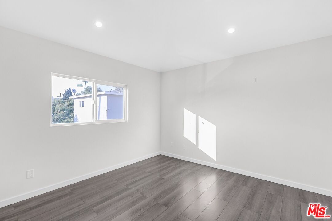3509 Kinney Street Los Angeles, CA 90065 - Photo 8 of 12 an empty room with wooden floor and windows