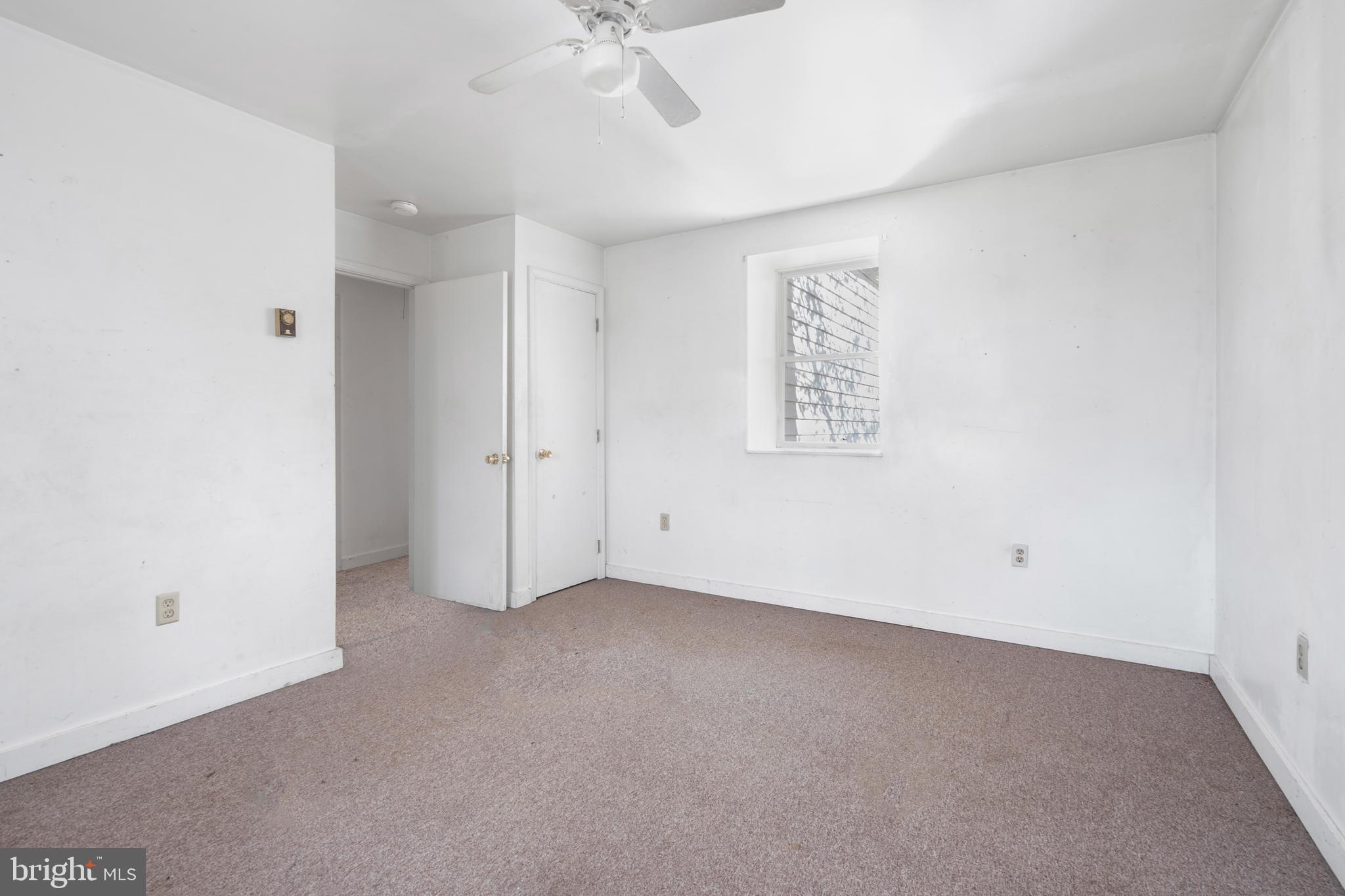 2481 Summit Point Road Summit Point, WV 25446 - Photo 23 of 35 an empty room with a ceiling fan and a window