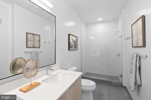a bathroom with a sink a toilet and mirror