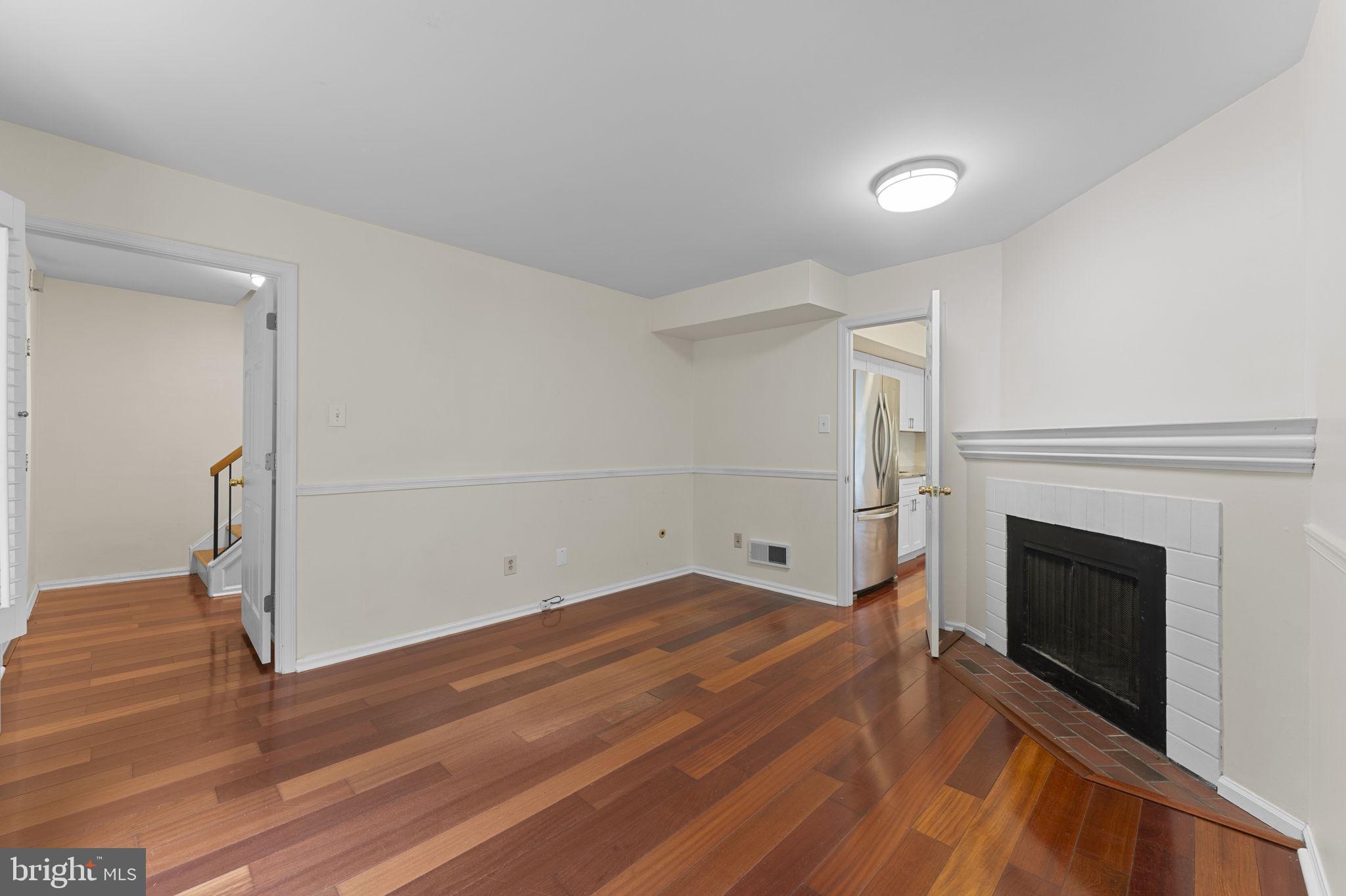 10 Elan Lane Chesterbrook, PA 19087 - Photo 11 of 39 Fireplace and flowing design leading to kitchen