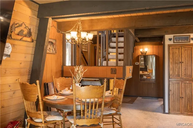 a living room with stainless steel appliances kitchen island granite countertop furniture and a large window