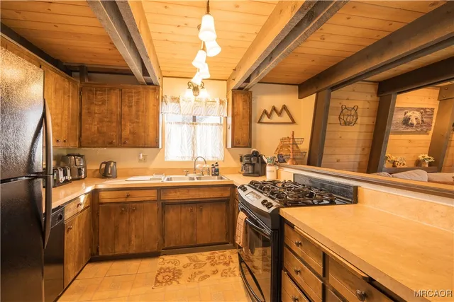 a kitchen with a sink stove and refrigerator