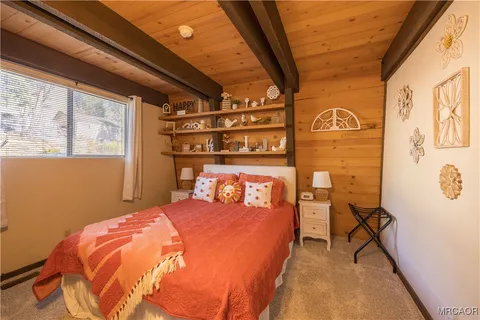 a bedroom with a bed and a mirror