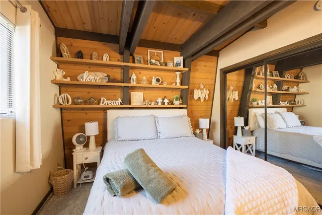 a bedroom with a bed and a mirror