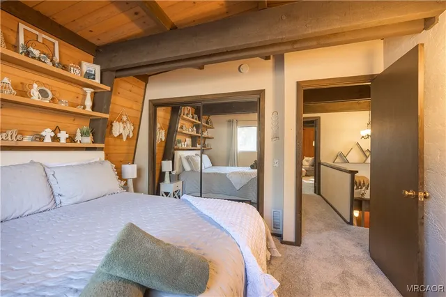 a kitchen with stainless steel appliances kitchen island granite countertop a refrigerator a stove a microwave oven with a dining table and chairs with wooden floor