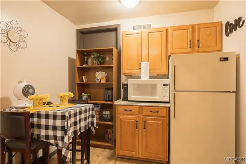 a bed room with a bed and a refrigerator