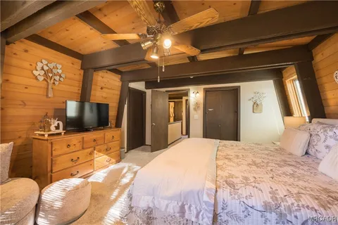a bedroom with a bed and a flat screen tv