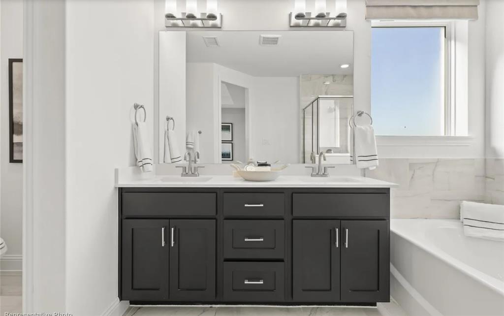 2504 Sturgis Street Forney, TX 75126 - Photo 16 of 24 a bathroom with a sink vanity and mirror