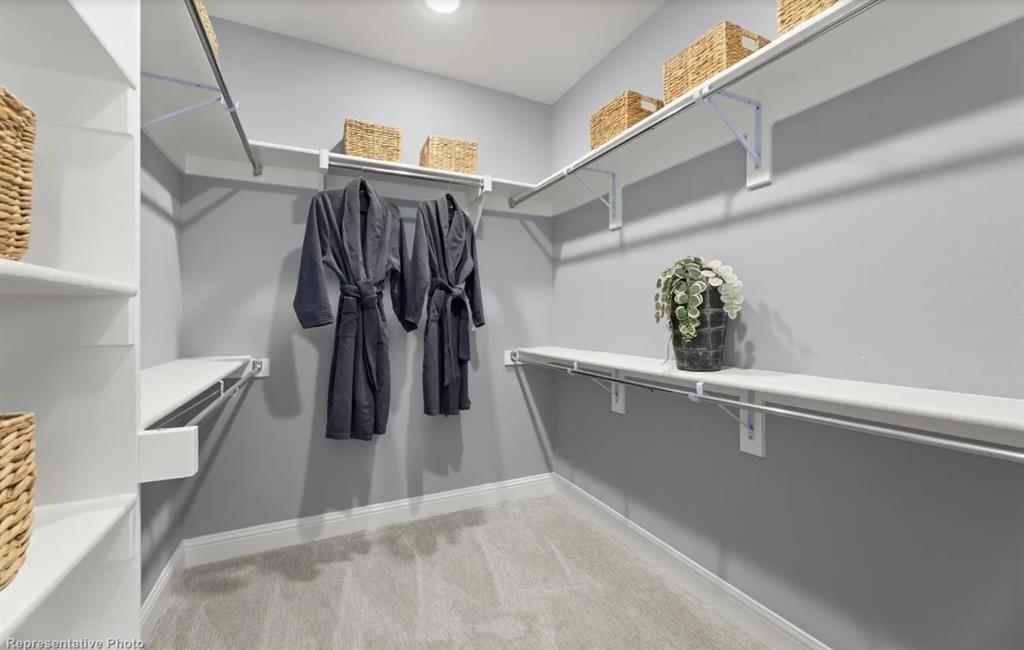 2504 Sturgis Street Forney, TX 75126 - Photo 17 of 24 a view of walk in closet with clothes and shoes