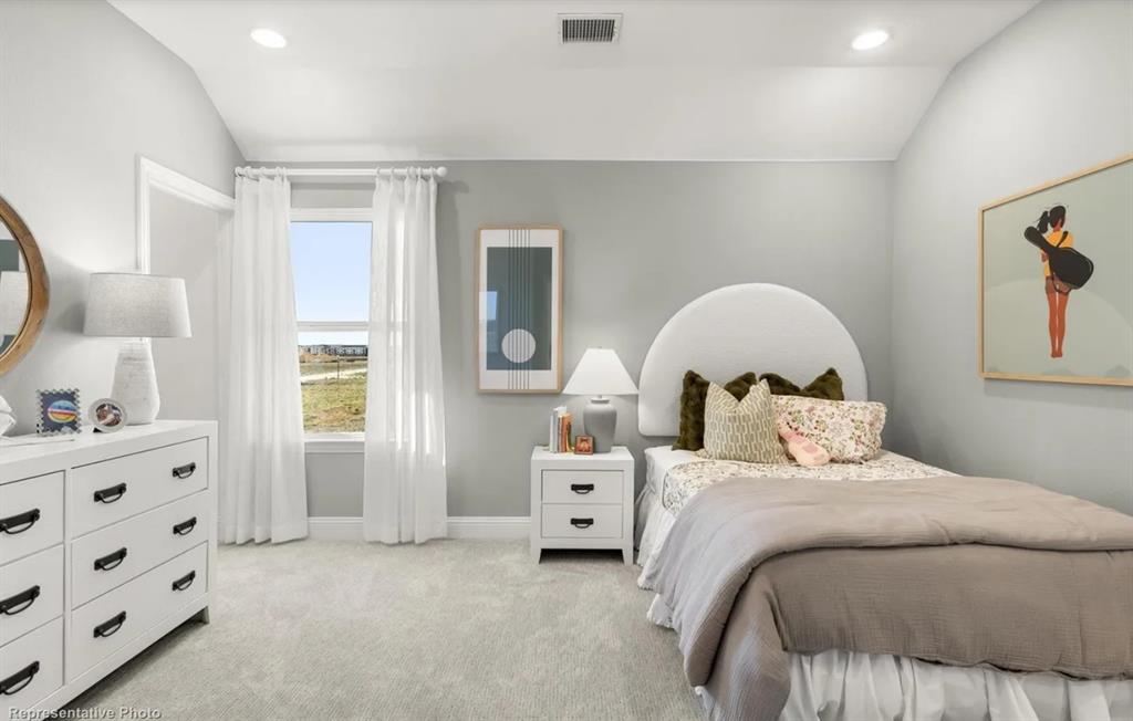 2504 Sturgis Street Forney, TX 75126 - Photo 19 of 24 a bedroom with a bed and a large mirror