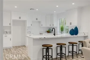 a kitchen with sink and cabinets