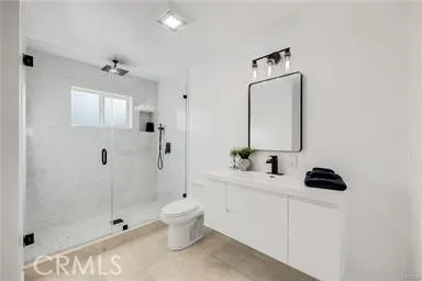 a bathroom with a sink mirror toilet and shower