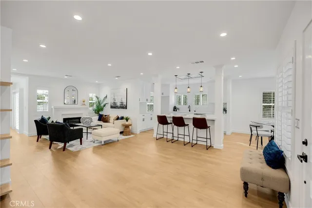a living room with furniture and a view of kitchen
