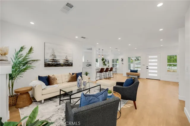a dining room with furniture and potted plants