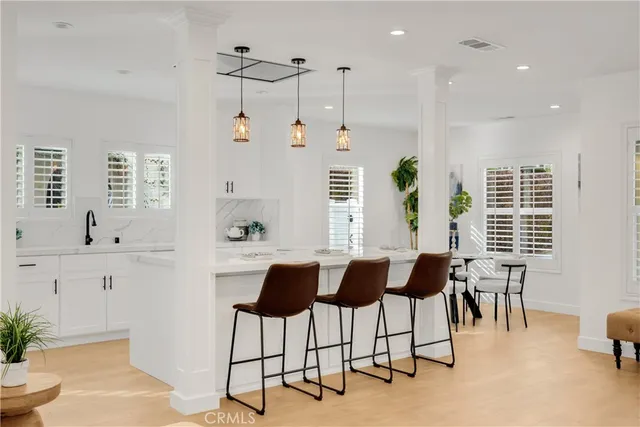 a view of a dining room with furniture and a potted plant