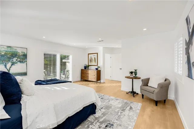 a patio with a table and chairs under an umbrella with a barbeque