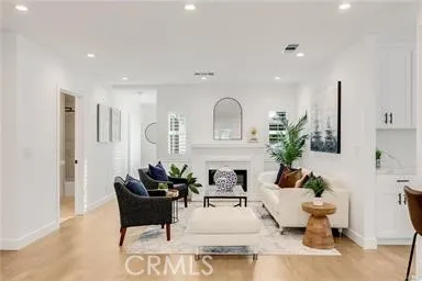 a living room with furniture and potted plants