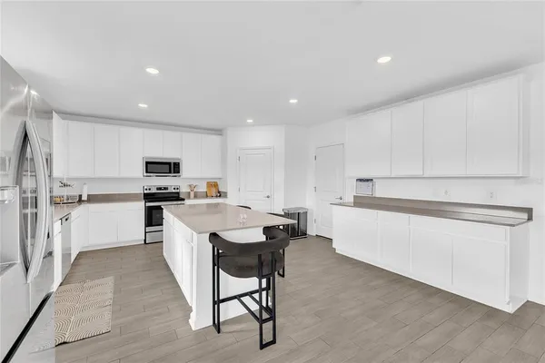 a kitchen with white cabinets and white appliances