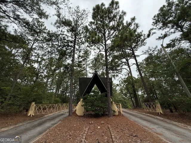 a backyard of a house with barbeque oven and outdoor seating
