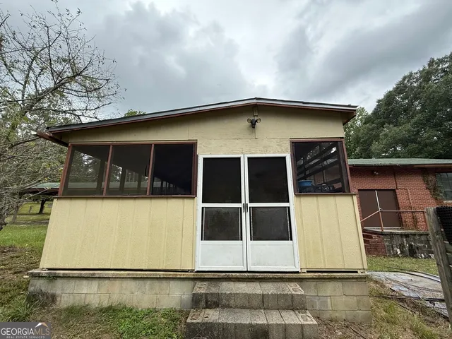 a view of a backyard with large trees