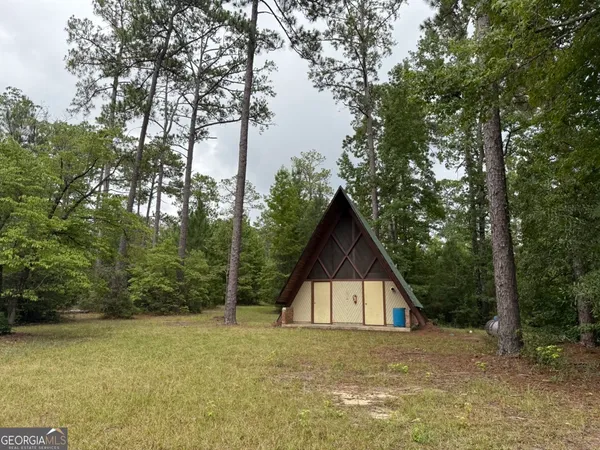 a backyard of a house with lots of trees