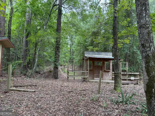 a view of outdoor space with deck and trees