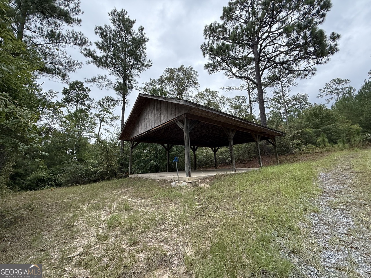2251 Boy Scout Road Byron, GA 31008 - Photo 31 of 46 a backyard of a house with wooden fence and barbeque oven